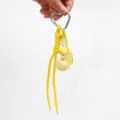 Close-up of yellow tennis racket and dice charm keychain with heart carabiner - Yellow