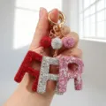 Gros plan de porte-clés alphabet incrustés de strass en rouge, argent et rose - Motif R / Rose