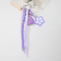Detail of purple handmade woven rope keychain with leather heart and cherry blossom - Purple