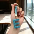 Sparkly blue rhinestone letter E keychain with gold-tone hardware hanging charm - Letter E