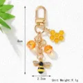 Detailed view of bee and honeycomb keychain charms with dimensions and weight - Bee Honeycomb