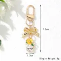 Korean style floral keychain with rhinestone bow and crystal drop dimensions detail - Yellow