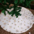 Close-up detail of white plush Christmas tree skirt with gold sequined snowflake embroidery. - Gold Snowflake 90cm