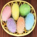 Detailed view of colorful textured foam Easter eggs arranged in a yellow decorative basket - Style 2