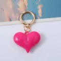 Detail of bright pink 3D acrylic heart keychain with elegant gold-tone ring clasp - Rose Red