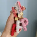 Detail of three sparkling rhinestone letter P keychains in red white and pink colors - Pink Rhinestone P
