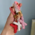 Detailed view of three luxury rhinestone-encrusted letter X keychains in varied colors - Initial X Style / Pink