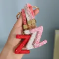 Close-up of handmade sparkling rhinestone letter Z keychains in red, white and pink colors - Initial Z Style / Pink
