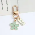 Korean style light green enamel daisy keychain with gold-finish metal pendant and tag - Daisy Pendant (With Hand Made Tag) / Light Green