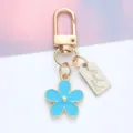 Charming blue enamel daisy flower keychain with gold metal hardware and engraved handmade tag - Daisy Pendant (With Hand Made Tag) / Blue