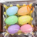 Six colorful speckled foam Easter eggs in a yellow basket with ribbons for decoration. - Fence Basket Style (Style 11)