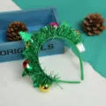 Close-up of Christmas tree headband with green tinsel and colorful baubles - Ball head buckle with light