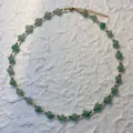 Detailed view of handmade necklace with green natural stone cube beads and gold accents - Necklace / Green Aventurine