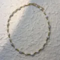 Close-up of a handmade necklace with natural pearls, howlite stones and gold beads - White Turquoise - Necklace