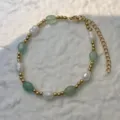 Close-up of a bracelet with natural pearls, green stones, and gold stainless steel beads - Green Aventurine - Bracelet