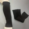Detailed view of black ribbed knit leg warmers, soft texture for winter warmth and fashion. - One Size / Black