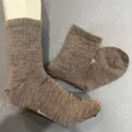 Detail view of solid color merino wool mid tube socks showing texture and foot form fit display. - S (36-40) / Dark Brown