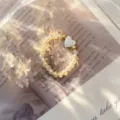 Macro view of an elegant elastic ring featuring yellow crystal beads and a shell heart. - Stretch / Yellow