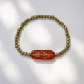 Detailansicht eines 18K Gold Edelstahlperlen-Armbands mit roter Glas-Rune-Plakette - Talisman-red