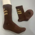 Brown knit wool blend mid-tube socks with woven English text detail close up display. - 36-40 / Dark Brown