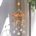 Dettaglio dell'acchiappasole in cristallo con lune che creano riflessi di luce arcobaleno - Ge06-red agate / 39cm