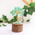 Close-up detail of the green crystal leaves and rustic wood base of the money tree - Aventurine Jade / 13cm Version
