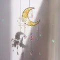 Detailed view of moon suncatcher with yellow stones and colorful light reflections - Citrine Style / 51cm