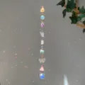 Close-up of a natural crystal suncatcher hanging against a light gray wall with rainbows - Colorful Butterfly Stone Style (GF07) / 71-81cm