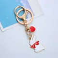 Close-up detail showing a cute white rabbit keychain with red bow and heart charm - Single OPP Bag Packaging / Bowtie Rabbit with Heart