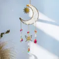 Close-up detail of natural crystal moon sun catcher with golden butterfly and prism drops - Clear Quartz / 40CM