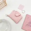 Detail shot of a sweet pink pleated mini wallet with snap button and white ring clip. - Pink