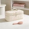 Detail view of creamy white heart-quilted travel makeup bag featuring pearl zipper pulls - Beige Heart