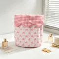 Pink bow quilted storage bag on a desktop with elegant perfume and soft window light - Pink