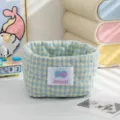Close-up of a blue and yellow plaid fabric storage basket with quilted heart patterns. - Blue-Yellow