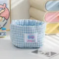 Close-up detail of the blue and white checkered fabric storage basket with quilted design - Blue