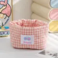 Detail of pink and white checkered fabric storage basket with quilted heart textures - Pink
