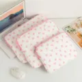 Close-up view of three different sized white laptop sleeves with cute pink bow patterns - 11" / White with Pink Bow
