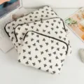Stack of three white laptop sleeves with black bow pattern in different sizes - 11" / Black and White Bow