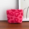 Detail view of a pink plush cosmetic bag with hot pink heart patterns and gold zipper. - Heart Relief Style / M / Rose Red