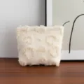 Close-up macro view of a cream-colored plush cosmetic bag with a fuzzy heart pattern - Heart Relief Style / M / Beige