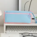 Detailed view of the blue and pink pastel canvas pencil case with round zipper pull. - Pink and Blue Patchwork