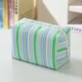Detail view of a fresh striped seersucker cosmetic bag with textured green and blue stripes - Green Colorful Stripes