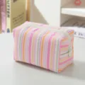 Macro view of the pink and orange striped seersucker fabric and zipper detail. - Pink Striped