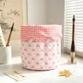 Close-up of pink bow quilted fabric storage basket for desktop organization. - Pink Bowknot Storage Basket
