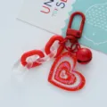 Close-up of a cute red acrylic heart keychain with a shiny bell and glitter details. - Heart Bell (F271-6) / Single Pack / Red