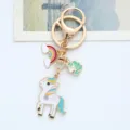 Detailed view of a golden unicorn keychain with colorful enamel rainbow charm - Single OPP Bag Packaging / Blue Rainbow Horse