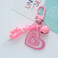 Close-up of pink heart acrylic keychain with glitter finish and bell detail. - Heart Bell (F271-6) / Single Pack / Pink