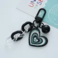 Detailed view of a glittery heart acrylic keychain with a black bell and chain. - Heart Bell (F271-6) / Single Pack / Black