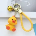 Detailed view of yellow resin duck keychain with knitted texture and gold bell charm - Yellow Chick / Yellow Chick