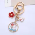Close-up of cute enamel rabbit and sakura charms on a gold alloy keychain - Blue Rabbit